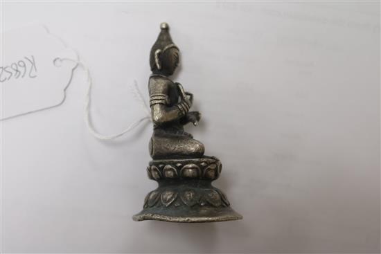 A white metal Buddha